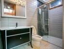 Modern bathroom with glass shower and large vanity mirror