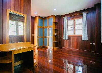 Spacious bedroom with wooden interior and large windows