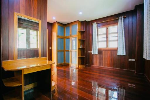 Spacious bedroom with wooden interior and large windows