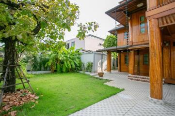 Exterior view of a wooden house with garden