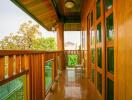 Wooden balcony with glass railing and outdoor seating