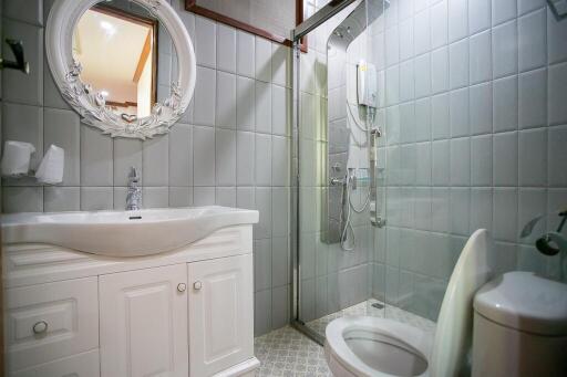 Modern bathroom with white vanity and glass shower