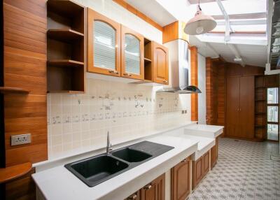 Spacious kitchen with wooden cabinets and modern fixtures