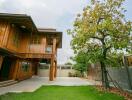 Spacious wooden house with a lush green yard