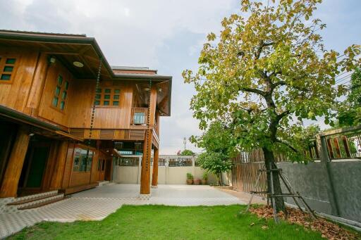 Spacious wooden house with a lush green yard