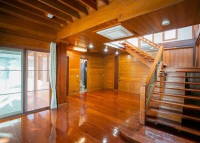 Spacious wooden living room with staircase