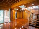 Spacious wooden living room with staircase