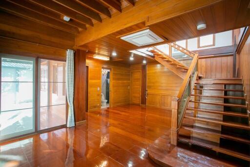 Spacious wooden living room with staircase