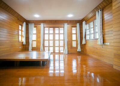 Spacious wooden living room with large windows