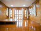 Spacious wooden living room with large windows