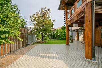 Outdoor patio with garden and wooden columns