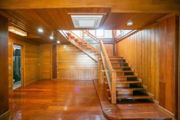 Wooden interior with staircase and polished floors