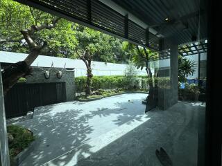 Modern outdoor space with tiled flooring, trees, and decorations