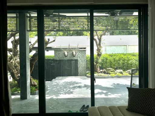 Living area with large glass doors opening to a backyard