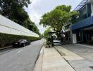 Quiet residential street with parked car and modern homes