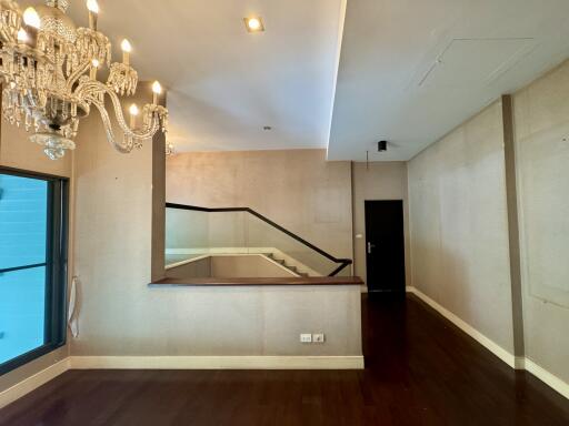 Living room with chandelier and wooden flooring