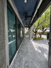 Exterior corridor with large windows and trees