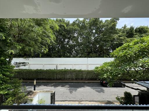 View of the street and trees from a balcony