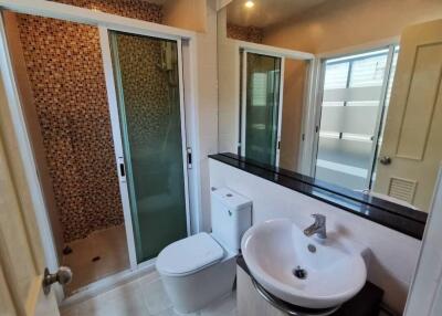 Modern bathroom with shower, toilet, and sink