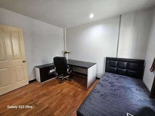 Bedroom with a desk and a bed