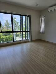 Spacious bedroom with large windows and natural light