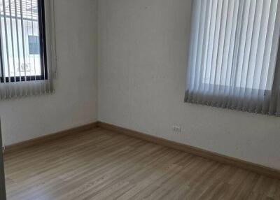 Bedroom with wooden floor and air conditioning unit