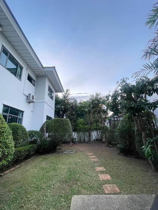 Photo of the exterior of a house with a garden and path