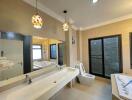 Well-lit modern bathroom with double sinks and large mirror