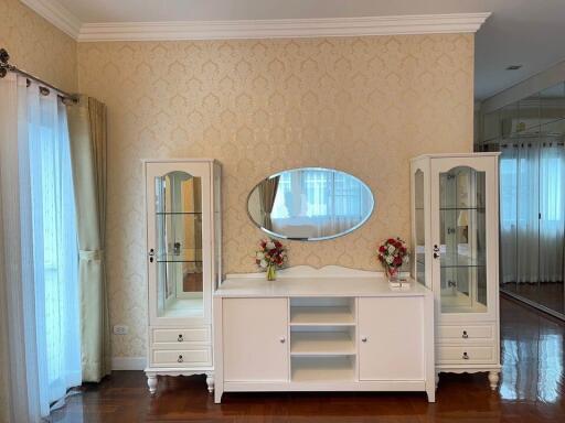 Bedroom with vanity and floral arrangements