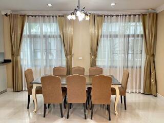 Dining room with chandelier and large windows