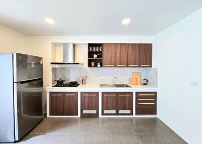 Modern kitchen with wooden cabinets and stainless steel appliances