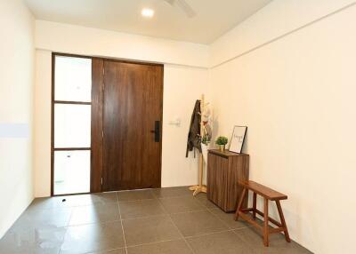 Entryway with wooden door and minimal decor