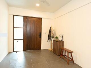 Entryway with wooden door and minimal decor