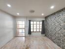 Living room with wooden flooring and stone accent wall