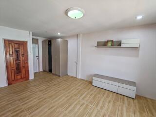 Minimalist bedroom with wooden door and tile flooring