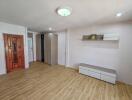 Minimalist bedroom with wooden door and tile flooring