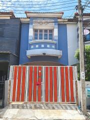 Two-story residential house with a modern facade and gated entrance