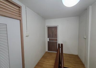 Hallway with wooden floor and doors