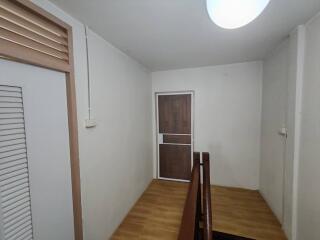 Hallway with wooden floor and doors