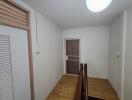 Hallway with wooden floor and doors