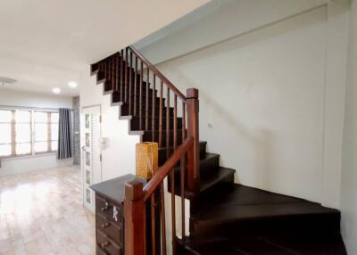 Spacious living area with wooden staircase