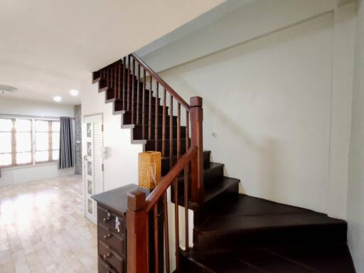 Spacious living area with wooden staircase