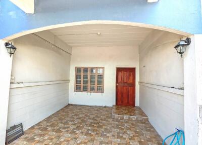 Front entrance with tiled flooring and wooden door