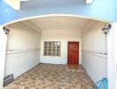 Front entrance with tiled flooring and wooden door