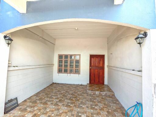 Front entrance with tiled flooring and wooden door