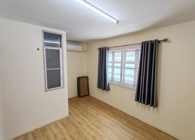 Empty room with wooden flooring and window