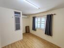 Empty room with wooden flooring and window