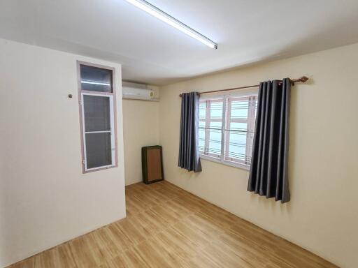 Empty room with wooden flooring and window