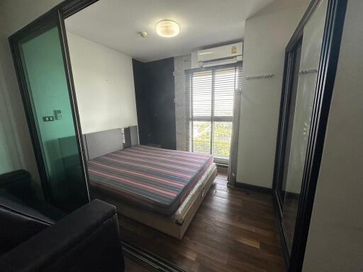 Modern bedroom with large windows and mirrored closet