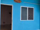 Blue exterior wall with door and window